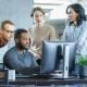 Forbes article business meeting four people looking at a computer